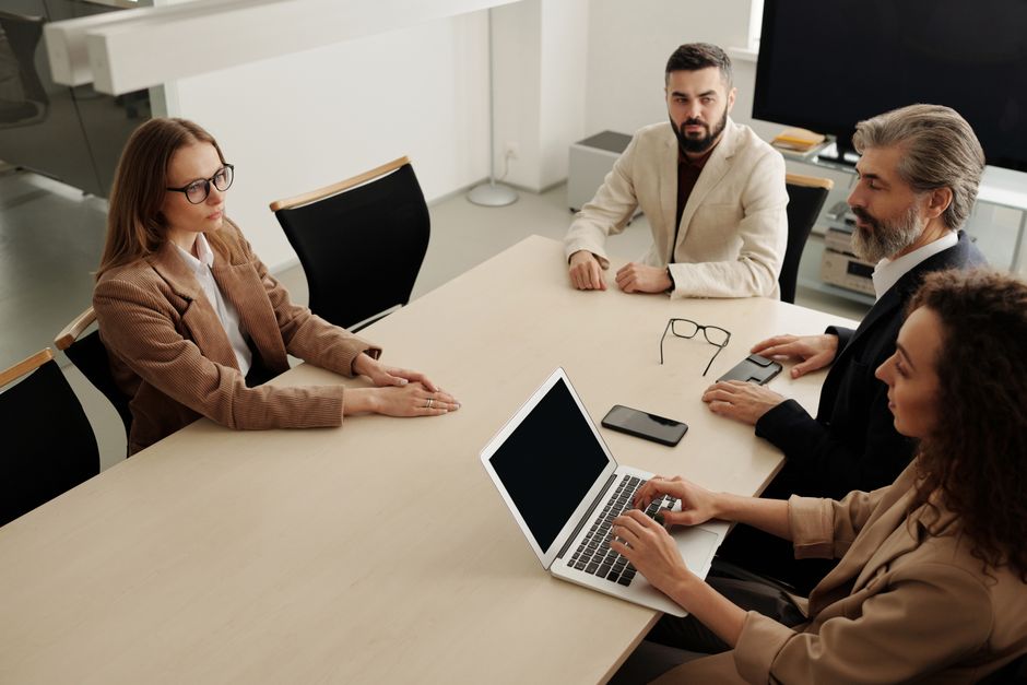 Group of professionals having a business meeting in a modern office setting.