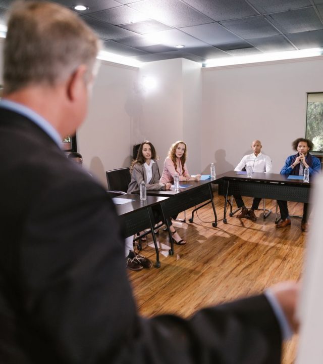 Diverse team in a business meeting discussing strategies in a conference room.